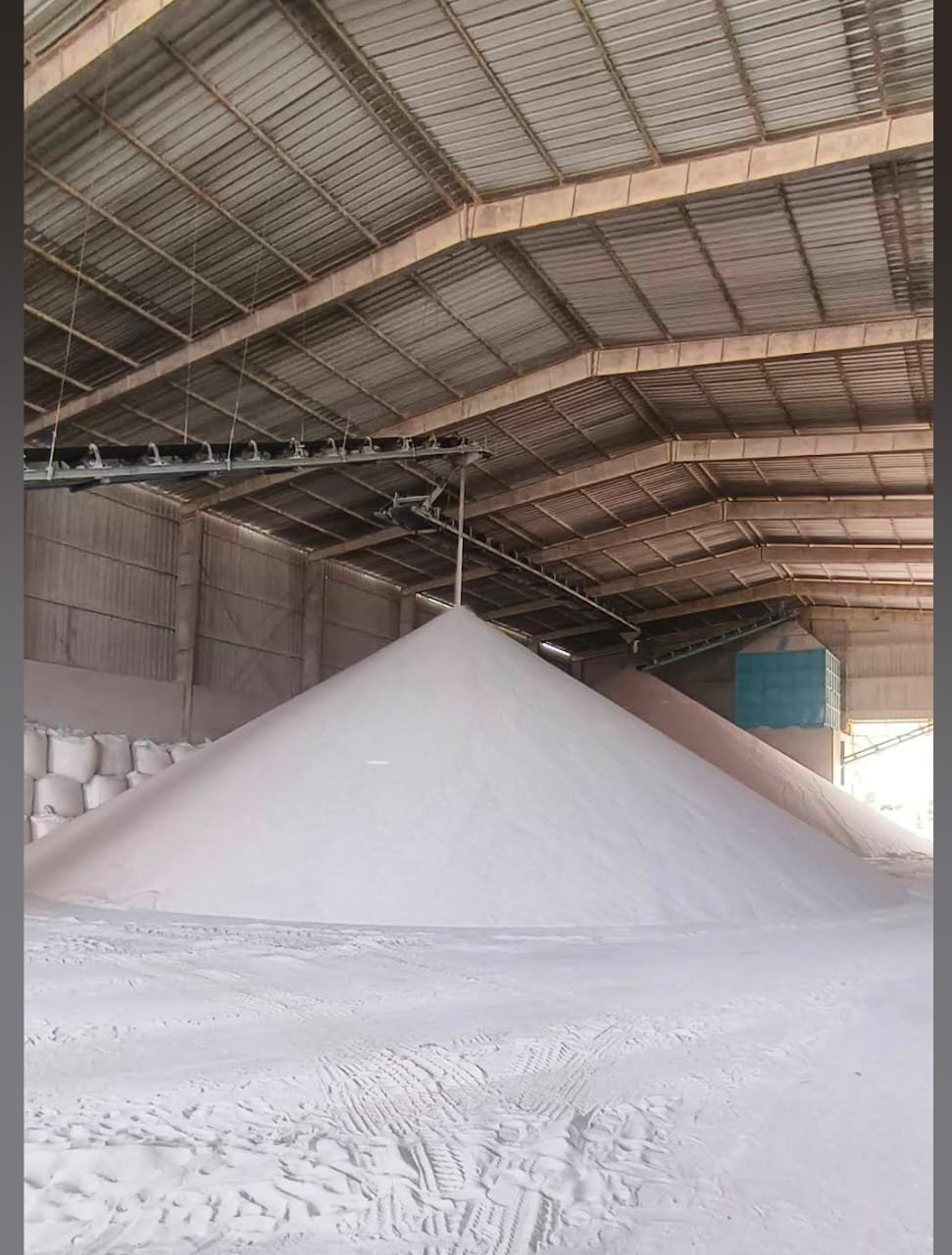 Covered warehouse stockpile of graded mineral ready stock with jumbo bags, Alham Exim yard