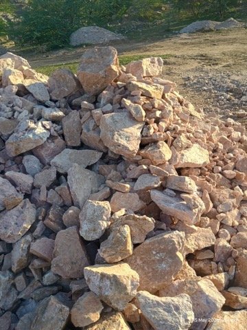 Limestone and feldspar boulders at mine-head stockpile