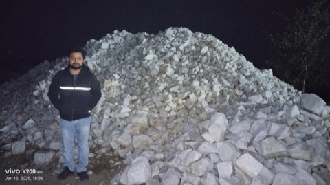 Alham Exim director inspecting quartz stockpile at mine