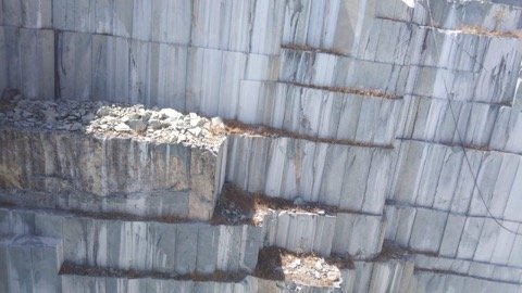 Quarry bench showing quartz vein deposits