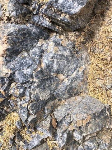 Mineralised rock face with quartz veining