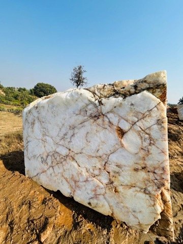 White quartzite block at quarry stockyard