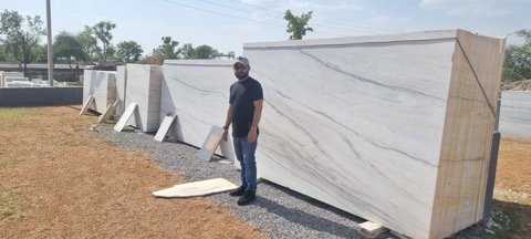 Director at slab yard reviewing export inventory